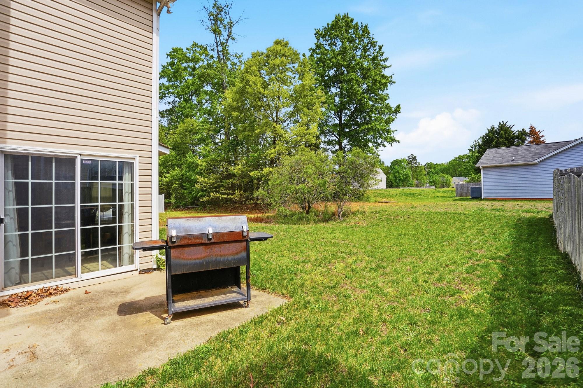 4404 Kiddle Lane Monroe, NC 28110 - Photo 44 of 48 a view of a backyard with a garden and seating area
