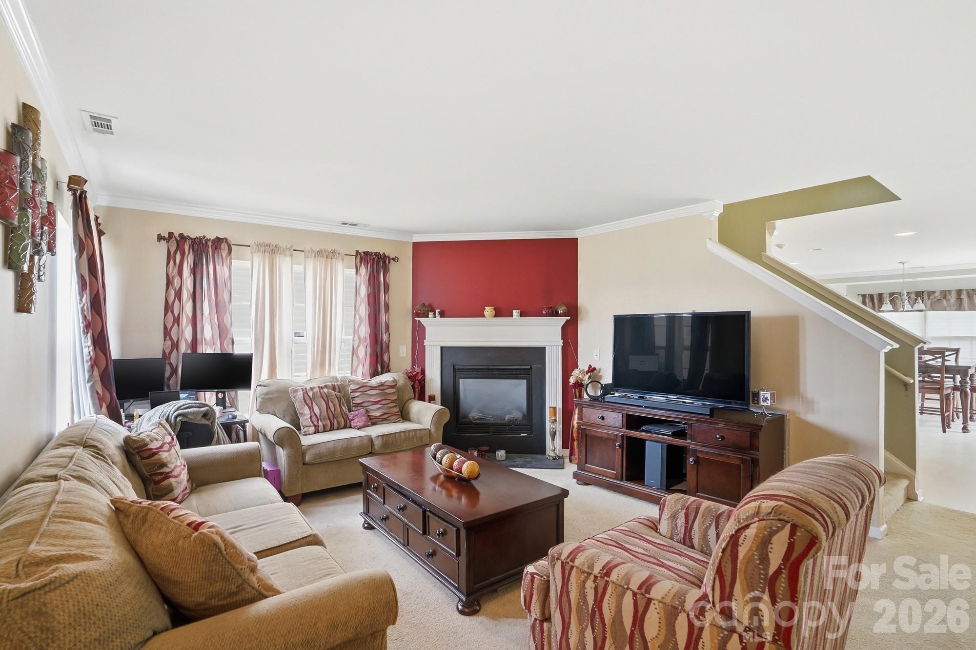 4404 Kiddle Lane Monroe, NC 28110 - Photo 8 of 48 a living room with furniture a fireplace and a flat screen tv