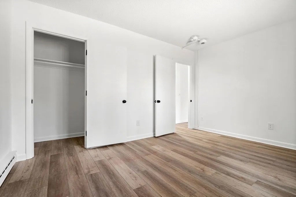 18 Pierce Street, Unit 3B Foxboro, MA 02035 - Photo 15 of 21 a view of an empty room with wooden floor