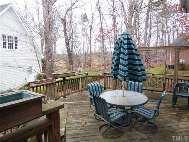 9101 Kettner Court Raleigh, NC 27615 - Photo 23 of 25 Outside, there is a lg 2-level Deck (the upper Deck off the Kitchen has grilling area) w/wooden porch swing. Patio/Deck