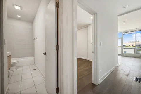 a view of a walk in closet and a bathroom
