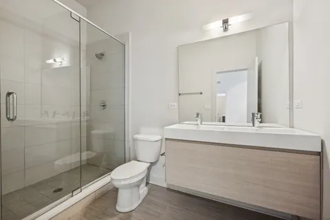 a bathroom with a toilet sink and shower