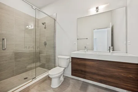 a bathroom with a toilet a sink and shower