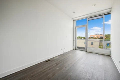 a view of a kitchen with a sink and dishwasher with wooden floor