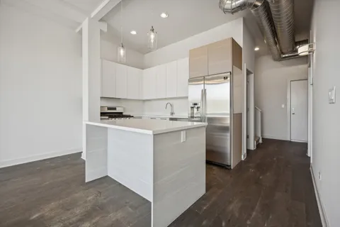 a kitchen with refrigerator cabinets and a sink