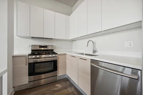a kitchen with stainless steel appliances granite countertop a sink and a stove