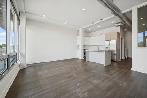 a view of a kitchen with wooden floor