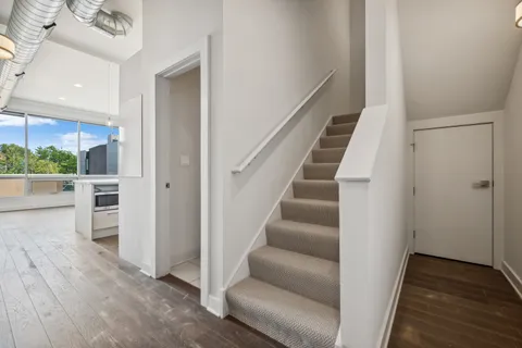a view of entryway with wooden floor and stairs