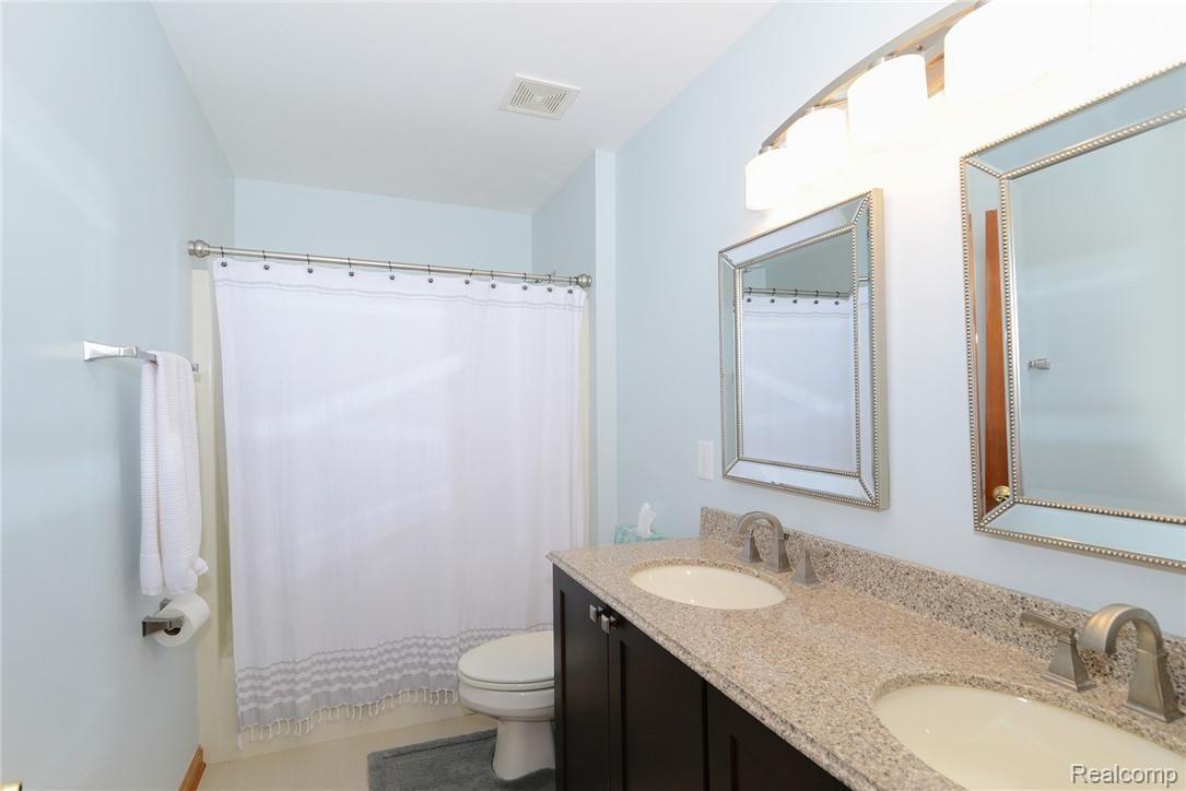 571 Timber Ridge Trail Howell, MI 48843 - Photo 27 of 38 Newly updated full bath with quartz double sinks, new lighting and ceramic flooring.