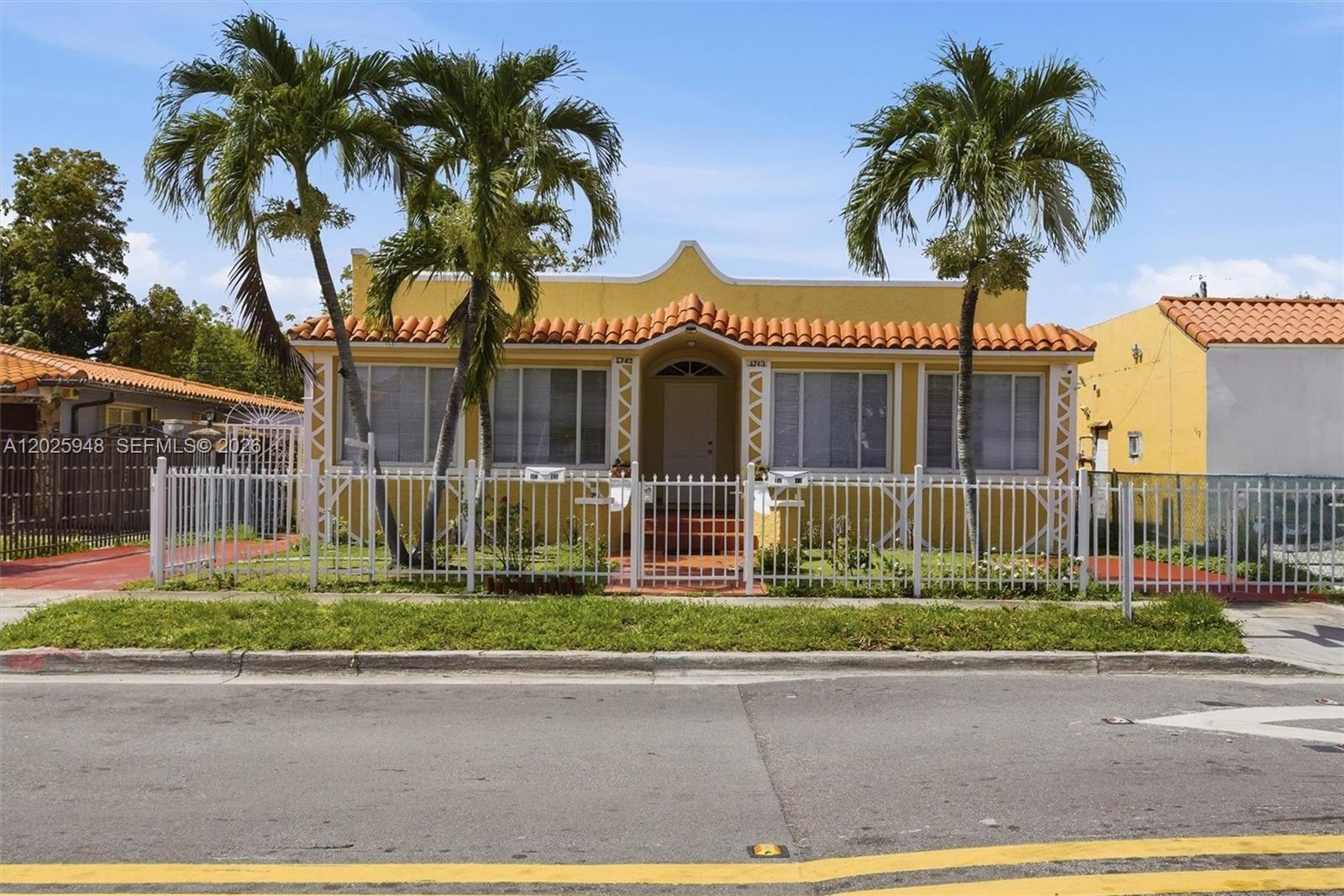 1745 Southwest 17th Street, Unit 2 Miami, FL 33145 - Photo 1 of 32 a front view of a house with a garden and a garage