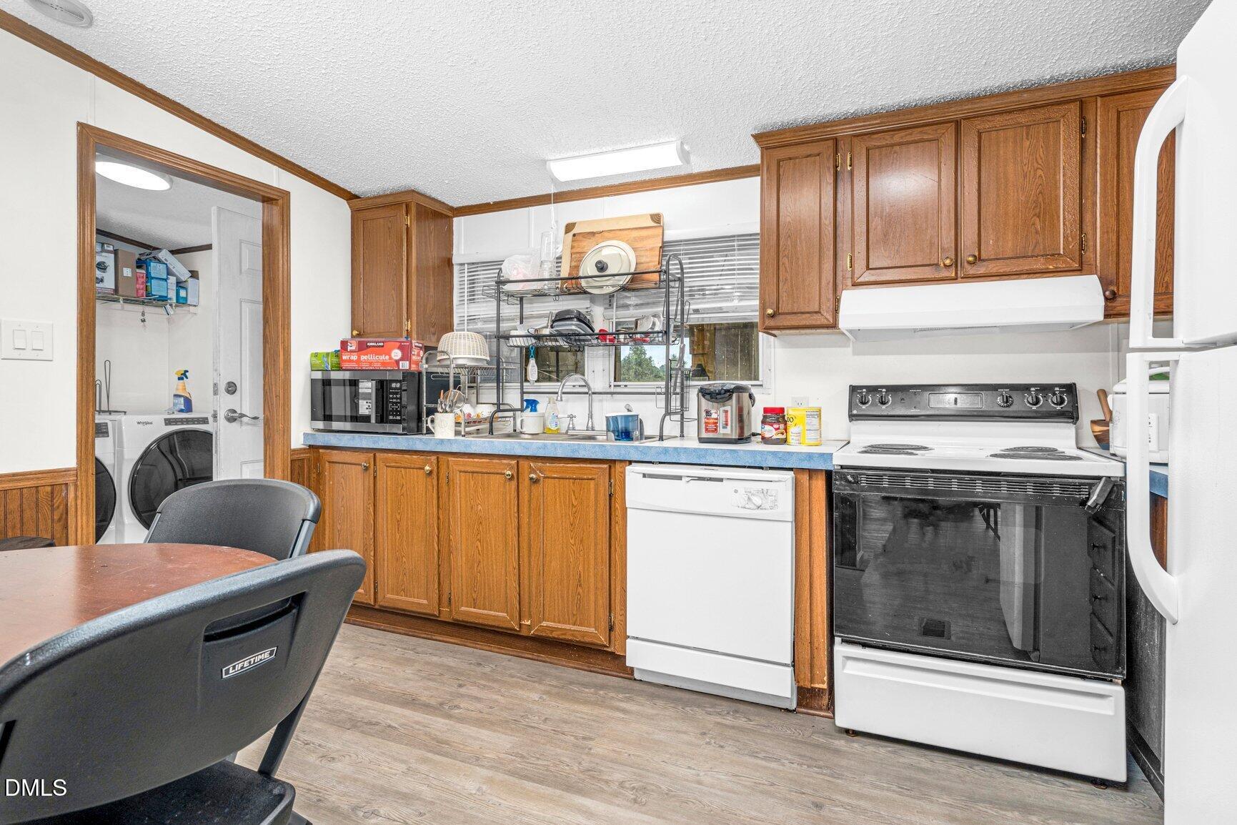 1835 Cokey Road Rocky Mount, NC 27801 - Photo 10 of 42 a kitchen with stainless steel appliances granite countertop a stove a sink dishwasher and cabinets