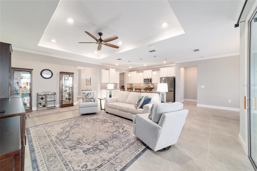 10318 Southwest 96th Loop Ocala, FL 34481 - Photo 17 of 67 a living room with furniture and a flat screen tv