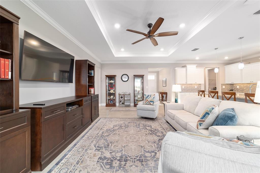 10318 Southwest 96th Loop Ocala, FL 34481 - Photo 18 of 67 a living room with furniture and a flat screen tv