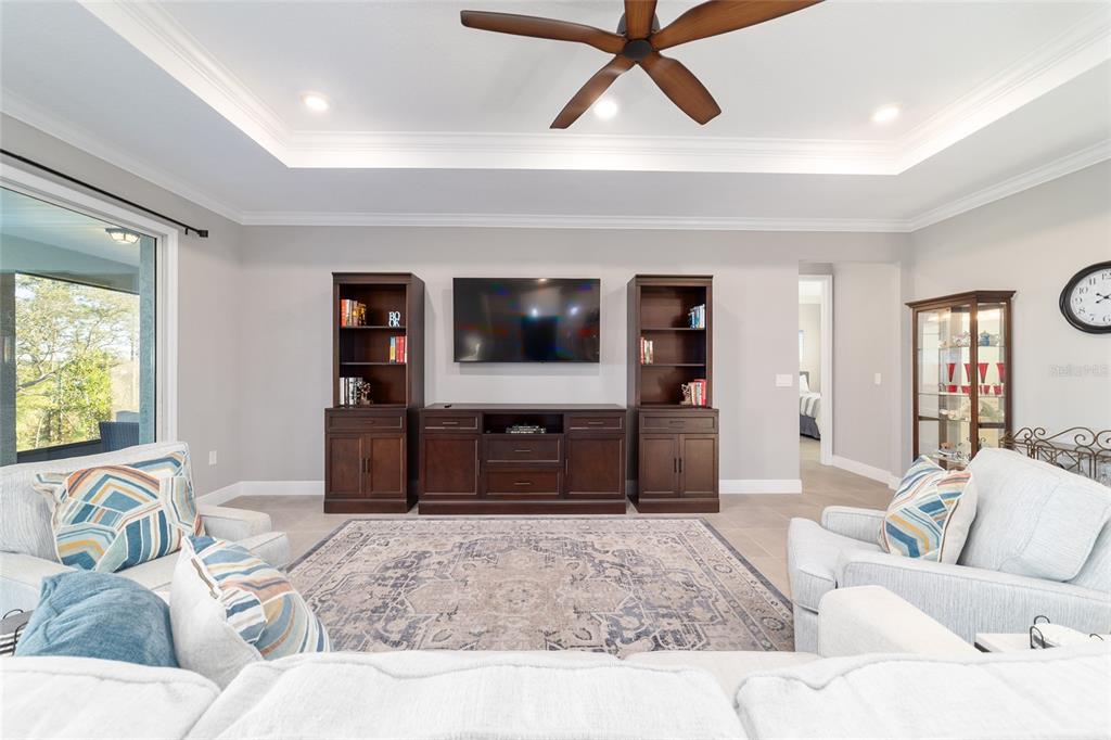 10318 Southwest 96th Loop Ocala, FL 34481 - Photo 20 of 67 a living room with furniture and a flat screen tv