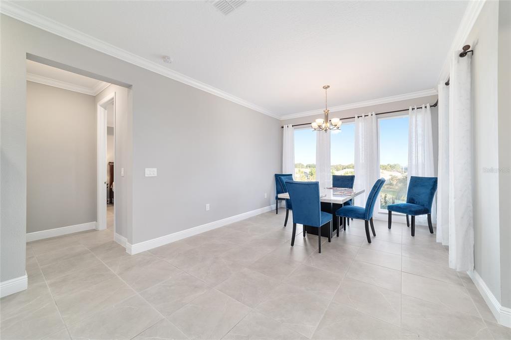 10318 Southwest 96th Loop Ocala, FL 34481 - Photo 30 of 67 a view of a dining room with furniture and chandelier