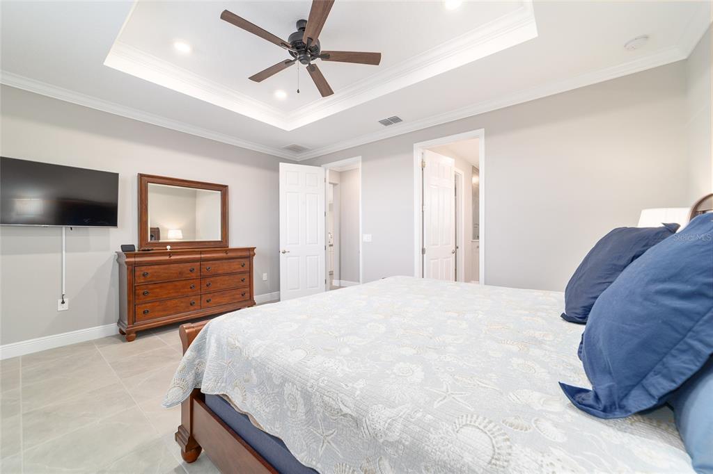 10318 Southwest 96th Loop Ocala, FL 34481 - Photo 36 of 67 a bedroom with a bed and a flat screen tv