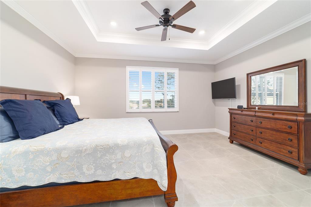 10318 Southwest 96th Loop Ocala, FL 34481 - Photo 37 of 67 a bedroom with a bed and a flat screen tv