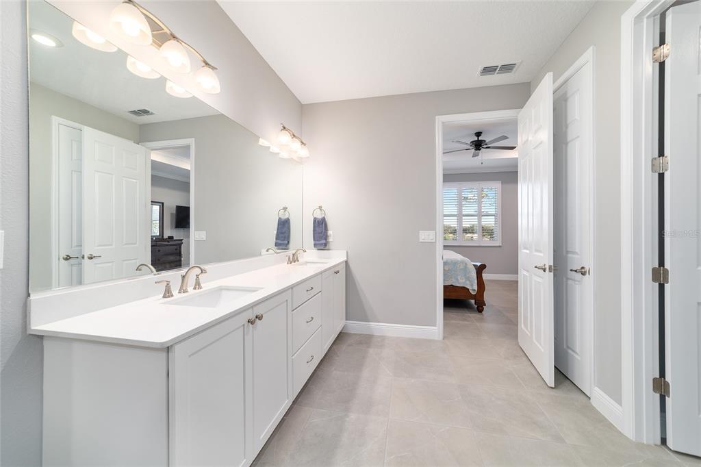 10318 Southwest 96th Loop Ocala, FL 34481 - Photo 40 of 67 a bathroom with a double vanity sink and mirror