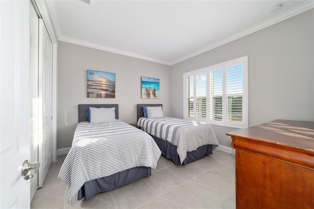 10318 Southwest 96th Loop Ocala, FL 34481 - Photo 45 of 67 a bedroom with two beds and a window