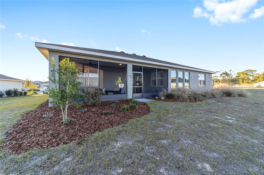 10318 Southwest 96th Loop Ocala, FL 34481 - Photo 65 of 67 a view of a house with backyard and garden
