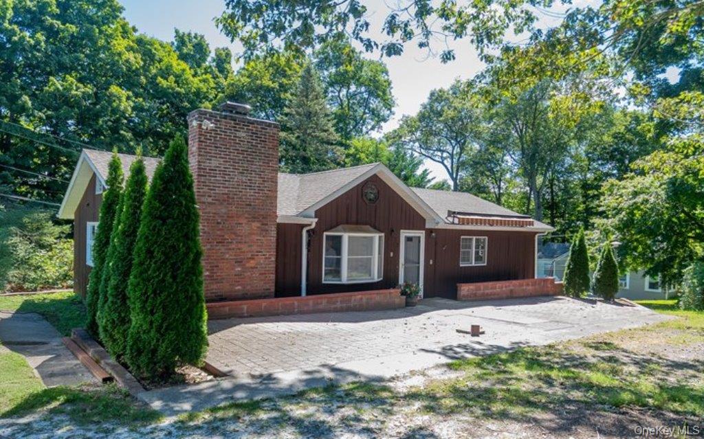 7 Harrimac Lane Putnam Valley, NY 10579 - Photo 1 of 41 a front view of a house with a garden and trees