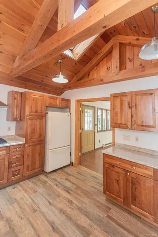 a spacious bathroom with a granite countertop sink and a bathtub
