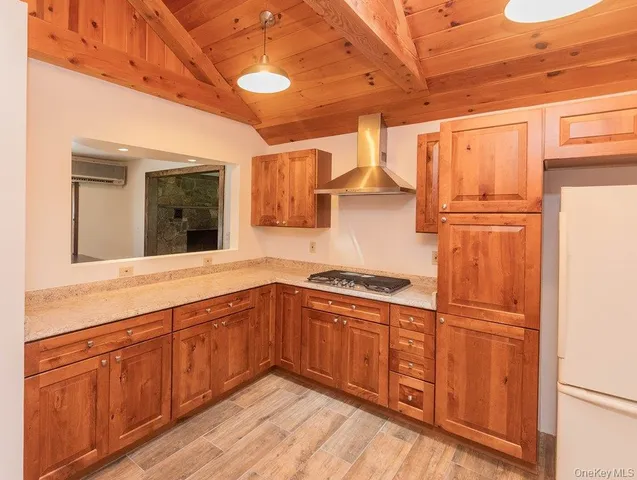 a kitchen with granite countertop stainless steel appliances a refrigerator and cabinets