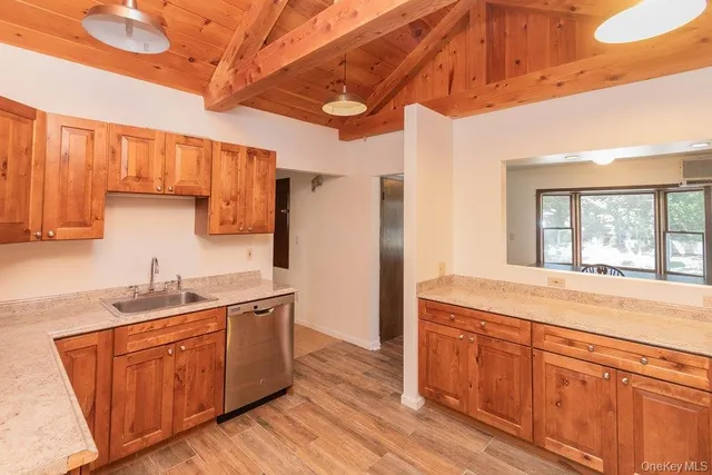 a kitchen with a sink and wooden cabinets