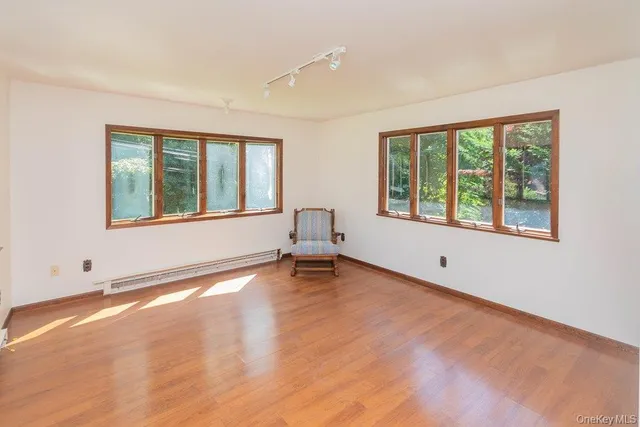 a big room with wooden floor and windows