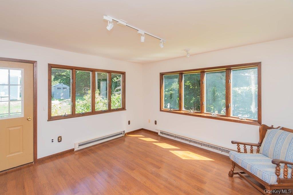 7 Harrimac Lane Putnam Valley, NY 10579 - Photo 17 of 41 a view of an empty room with a window and wooden floor