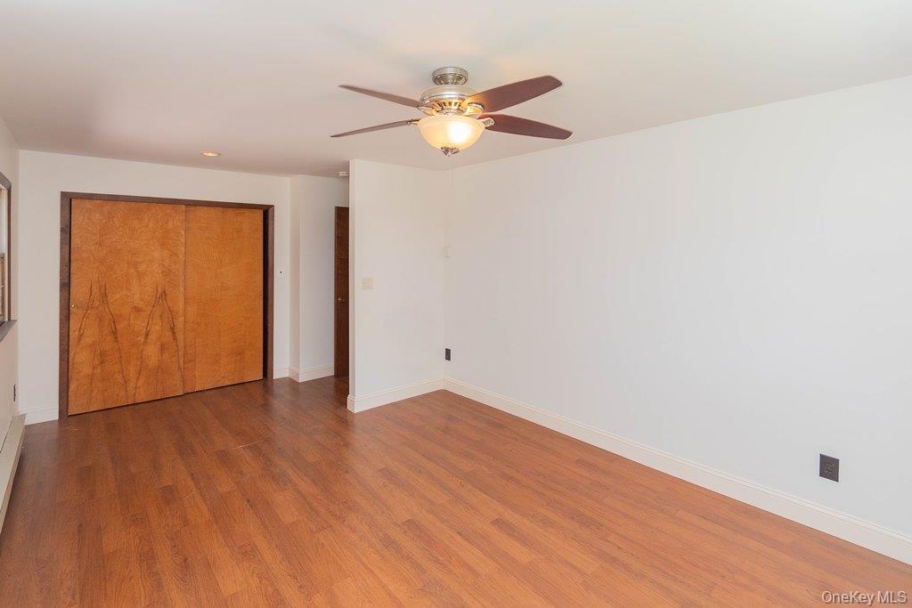 7 Harrimac Lane Putnam Valley, NY 10579 - Photo 19 of 41 a view of an empty room with wooden floor and a ceiling fan
