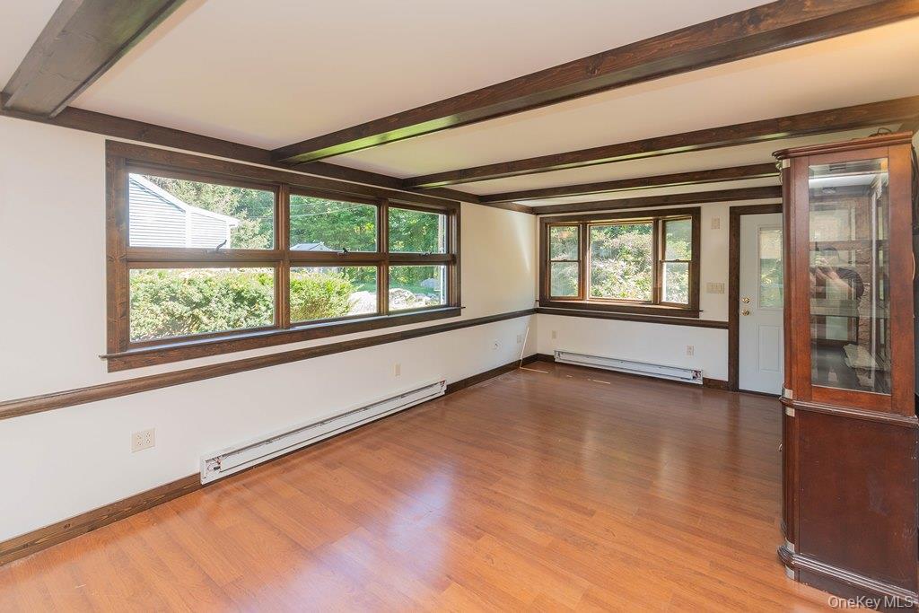 7 Harrimac Lane Putnam Valley, NY 10579 - Photo 6 of 41 a view of an empty room with a window and wooden floor