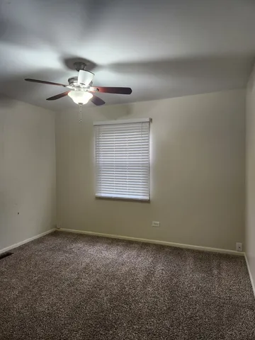 a view of room with a ceiling fan and window