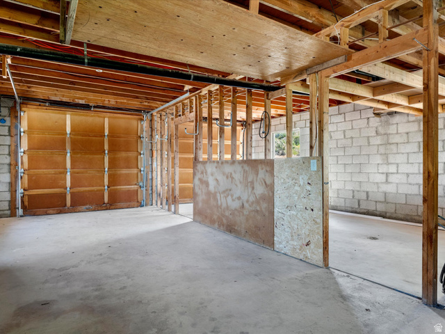 85 B Street, Unit 22 St. Charles, ID 83272 - Photo 29 of 35 Unfinished interior space featuring a concrete floor, exposed wood framing, and block wall construction