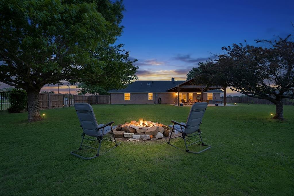 328 East Vaughn Road Cleburne, TX 76031 - Photo 1 of 1 a view of a table and chairs in the garden