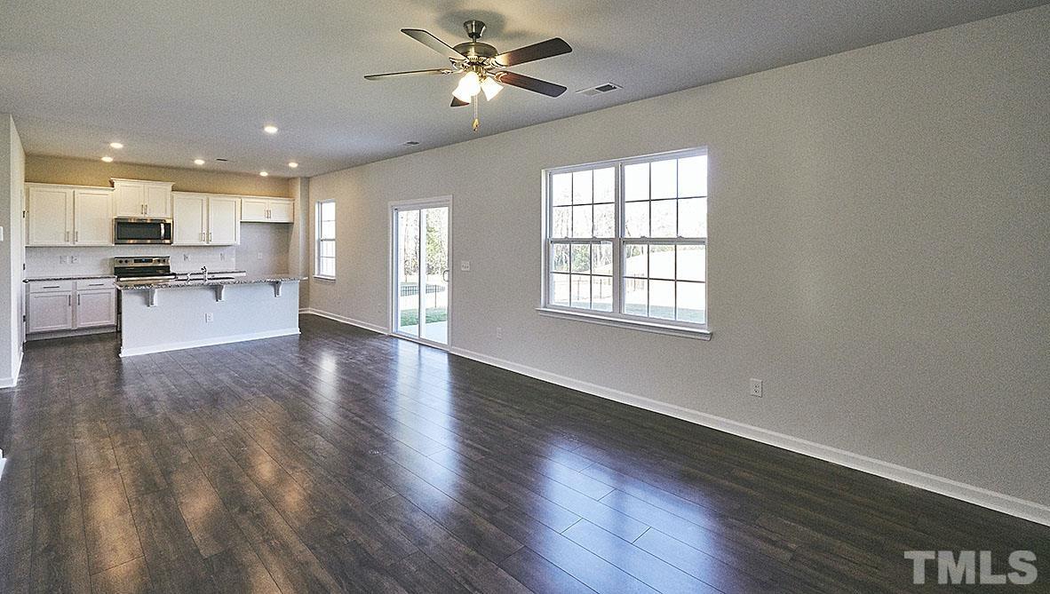 1023 Saddlebrook Drive Rocky Mount, NC 27804 - Photo 11 of 27 a view of an empty room with a kitchen and wooden floor