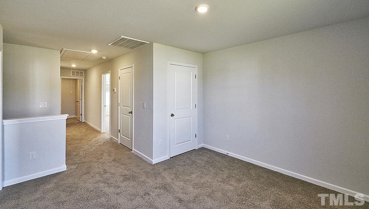 1023 Saddlebrook Drive Rocky Mount, NC 27804 - Photo 16 of 27 an empty room with closet and wooden floor