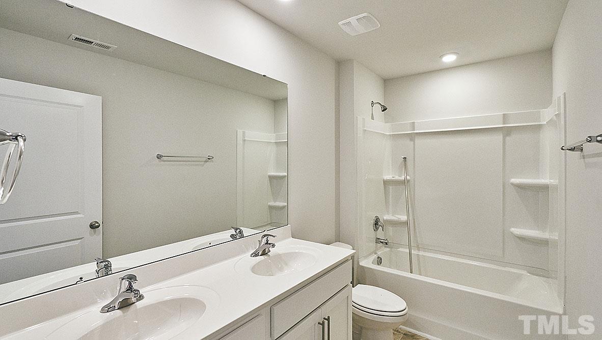 1023 Saddlebrook Drive Rocky Mount, NC 27804 - Photo 21 of 27 a bathroom with a sink a toilet and shower