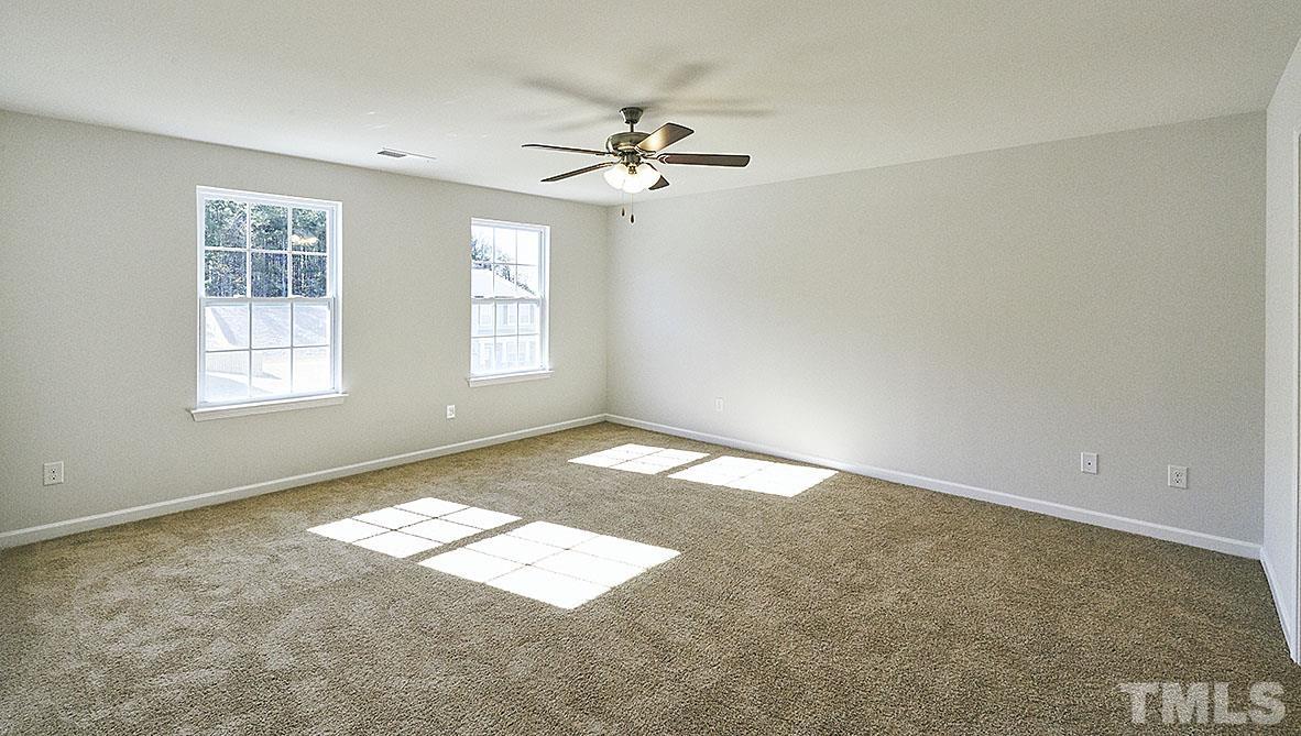 1023 Saddlebrook Drive Rocky Mount, NC 27804 - Photo 22 of 27 an empty room with windows and fan