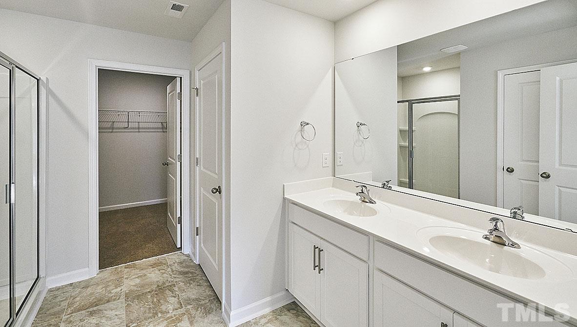 1023 Saddlebrook Drive Rocky Mount, NC 27804 - Photo 24 of 27 a bathroom with a sink and a mirror