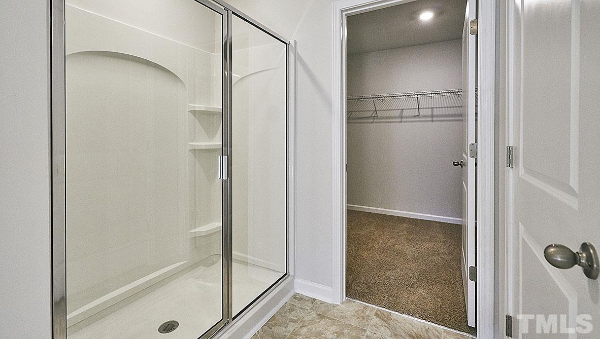 1023 Saddlebrook Drive Rocky Mount, NC 27804 - Photo 26 of 27 a bathroom with a glass shower door