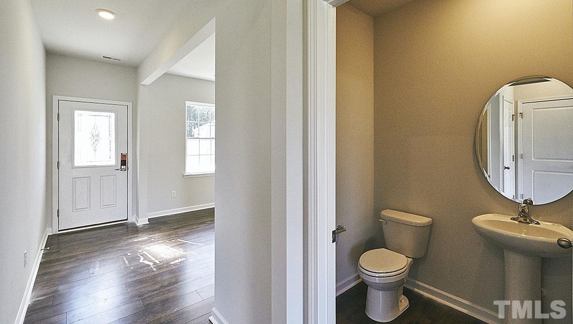 1023 Saddlebrook Drive Rocky Mount, NC 27804 - Photo 4 of 27 a bathroom with a toilet a sink and mirror