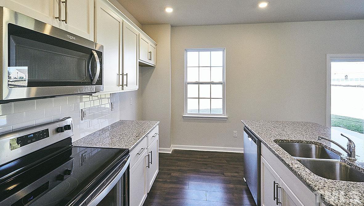 1023 Saddlebrook Drive Rocky Mount, NC 27804 - Photo 5 of 27 a kitchen with a stove and a microwave
