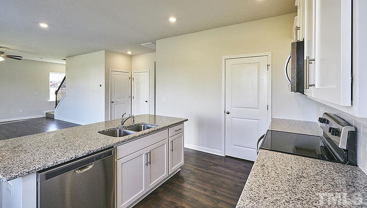 1023 Saddlebrook Drive Rocky Mount, NC 27804 - Photo 7 of 27 a kitchen with a sink stove and cabinets