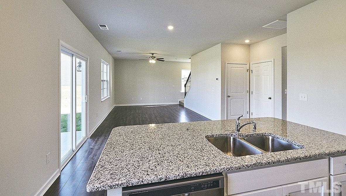 1023 Saddlebrook Drive Rocky Mount, NC 27804 - Photo 8 of 27 a kitchen with a sink and a refrigerator