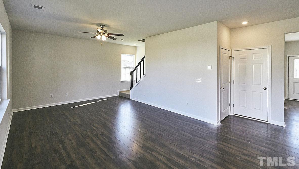 1023 Saddlebrook Drive Rocky Mount, NC 27804 - Photo 10 of 27 an empty room with wooden floor fan and windows
