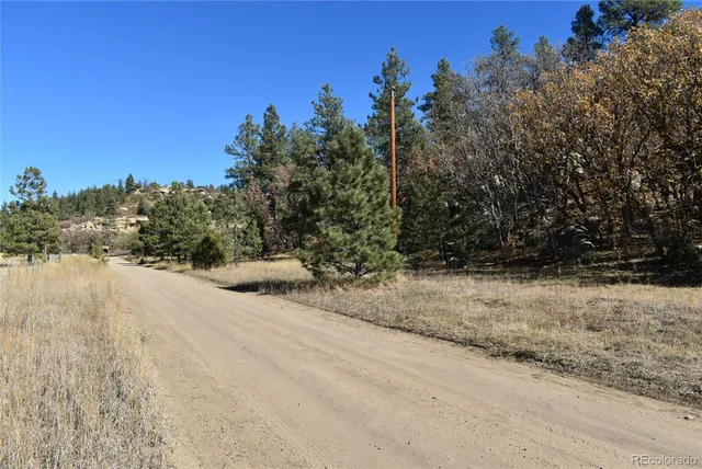 a backyard of a house with a yard and outdoor seating