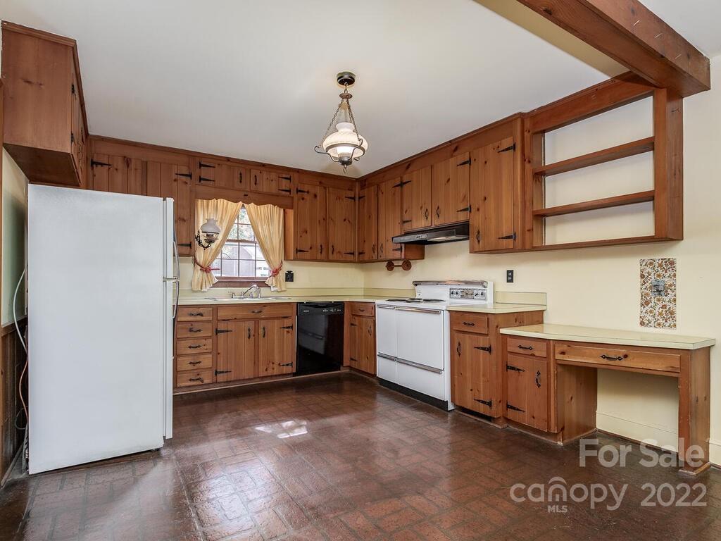 627 Sandridge Road Charlotte, NC 28210 - Photo 10 of 19 a kitchen with a sink window and cabinets