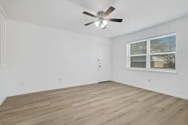 wooden floor in an empty room with a window