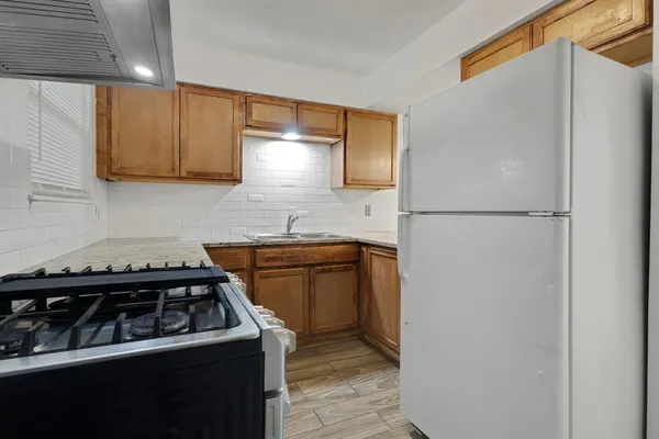 a kitchen with a stove and a refrigerator
